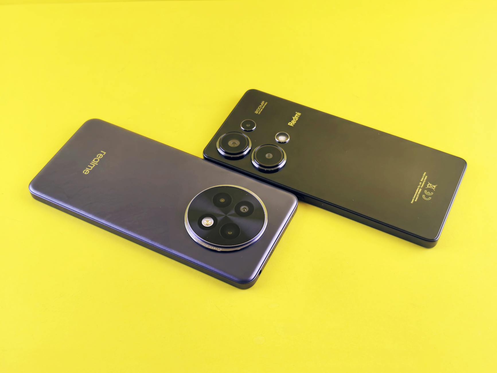 Two modern smartphones in a sleek, minimalist design on a vibrant yellow background.
