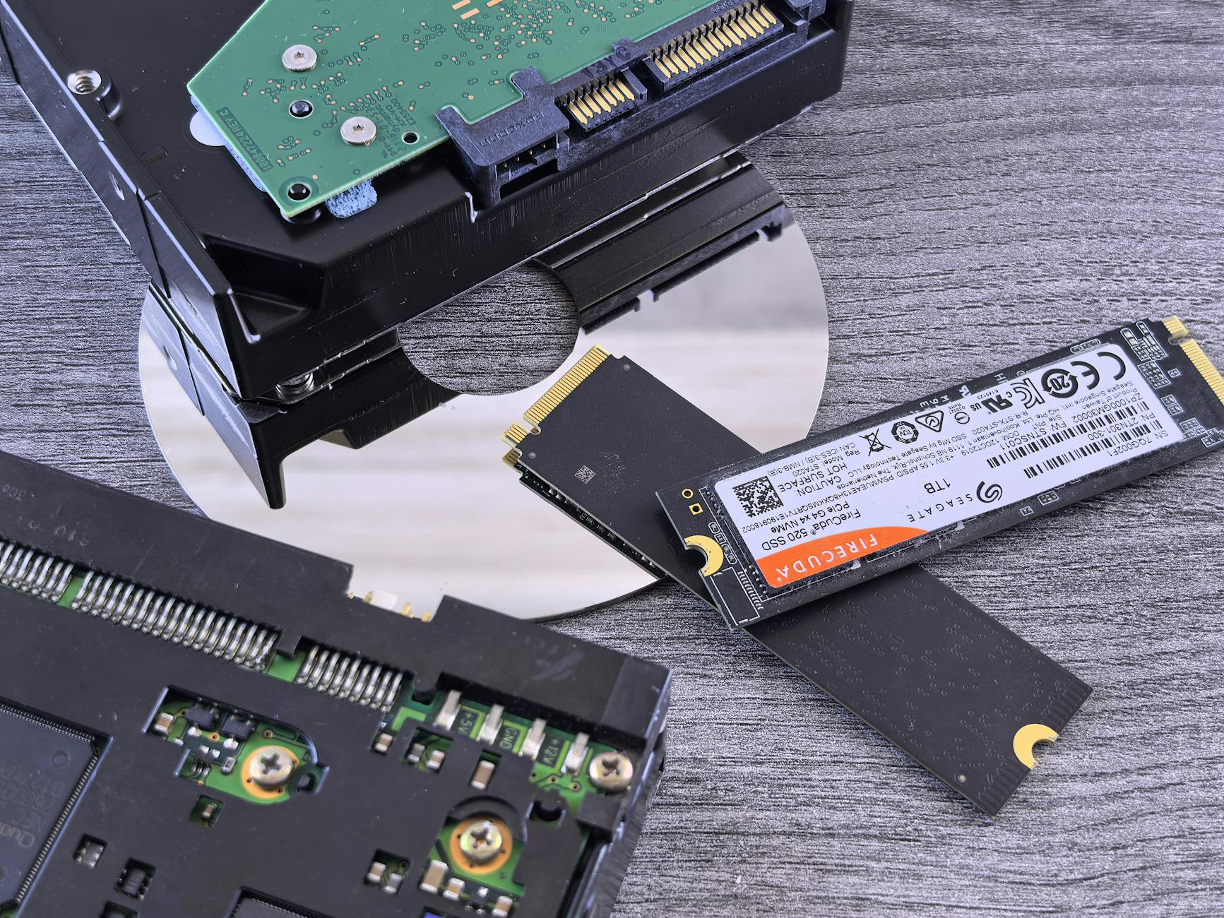 Contrasting data storage technologies: NVMe SSD, HDD, and CD.