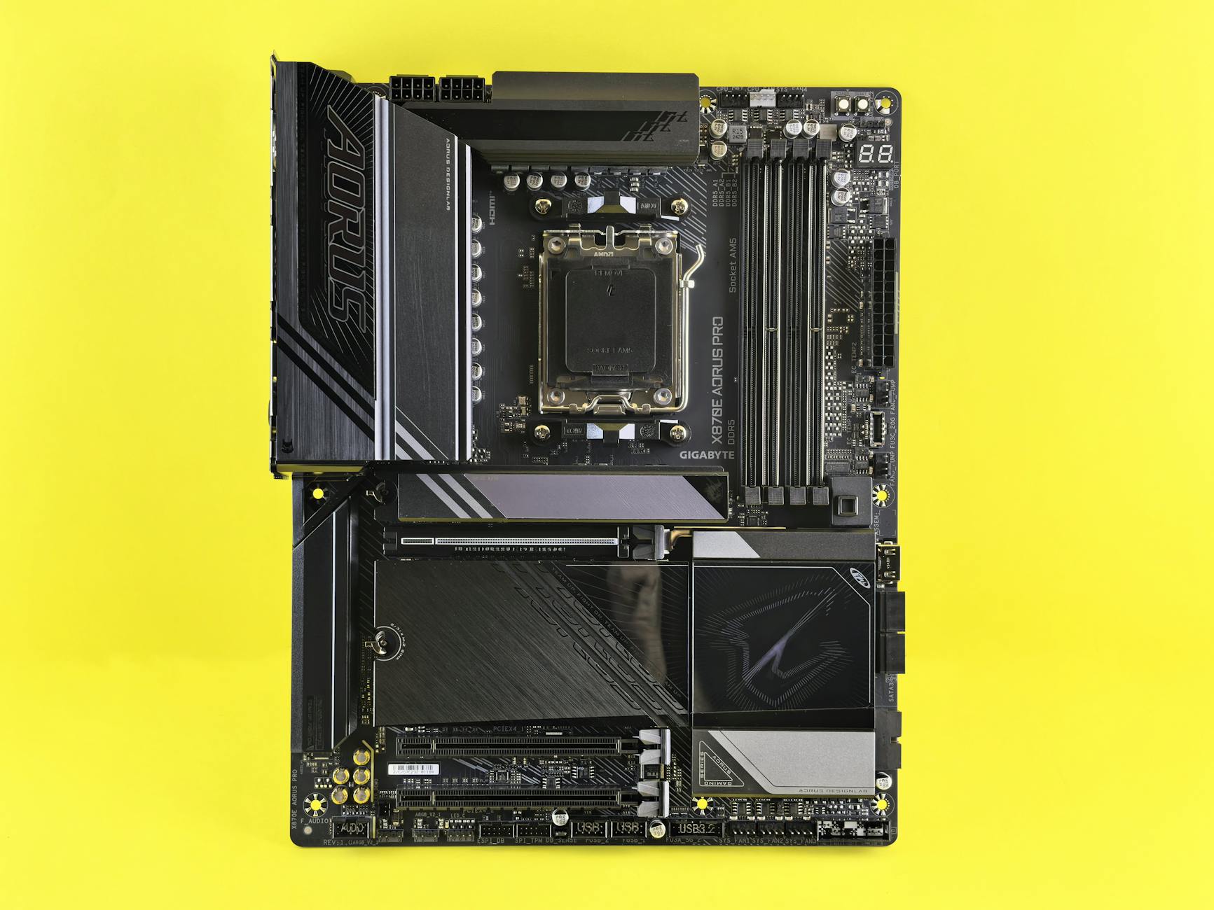 A powerful GIGABYTE motherboard displayed on a vibrant yellow background, showcasing technology.